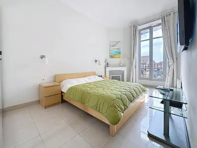 a bedroom with a bed and a window at 2 bedroom Forville. 8 mins from the Palais. 328 in Cannes
