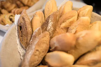 a pile of bagels sitting on top of a table at Hotel Abrial by Soniho in Cannes