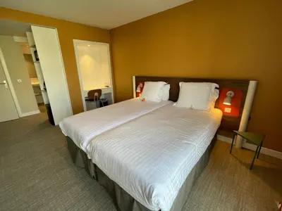 a bedroom with a large bed with white sheets and pillows at Hotel Abrial by Soniho in Cannes