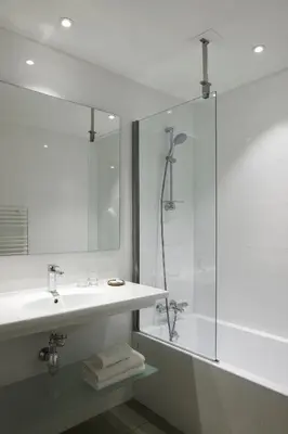 a bathroom with a sink and a glass shower at Hotel Abrial by Soniho in Cannes