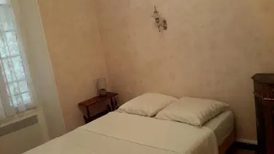 a small bedroom with two beds and a window at Good location flat in Cannes