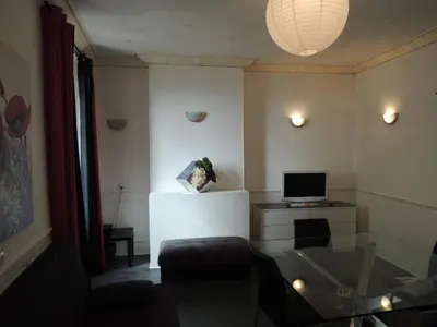 a living room with a glass table and a television at Good location flat in Cannes