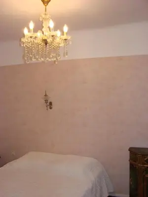 a bedroom with a chandelier hanging from the ceiling at Good location flat in Cannes