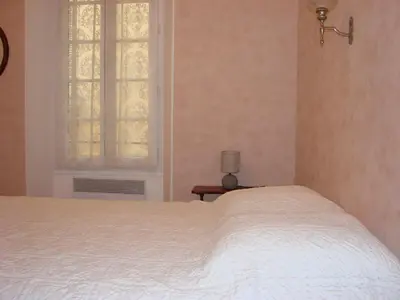 a bedroom with a white bed and a window at Good location flat in Cannes
