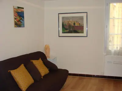 a living room with a couch and a picture on the wall at Good location flat in Cannes