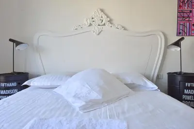 a white bed with white sheets and pillows at 1-Br Apartment Sea View Steps from Beaches in Cannes