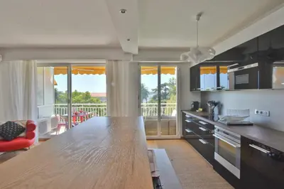 a kitchen with a large wooden counter top in a room at 1-Br Apartment Sea View Steps from Beaches in Cannes