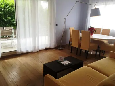a living room with a couch and a table at Arthur Properties Bel Air in Cannes