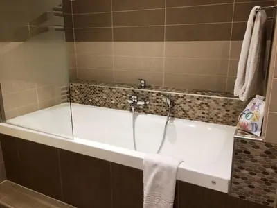 a bath tub in a bathroom with a shower at Arthur Properties Bel Air in Cannes