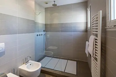 a bathroom with a shower and a toilet and a sink at Arthur Properties Bel Air in Cannes