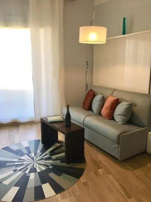 a living room with a couch and a coffee table at Arthur Properties Bel Air in Cannes