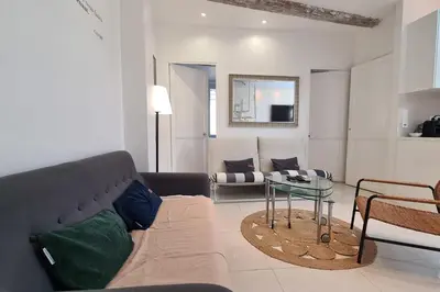 a living room with a couch and a table at Old harbor 3-bedroom apt charming & unique ! in Cannes