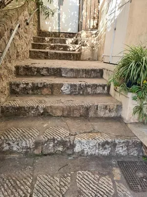 a set of stone stairs leading to a door at Old harbor 3-bedroom apt charming & unique ! in Cannes