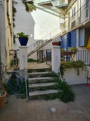 a set of stairs leading to a building with a plant at Old harbor 3-bedroom apt charming & unique ! in Cannes
