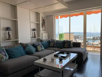 a living room with a couch and a table at O Festival Palace, terrace with panoramic sea view in Cannes
