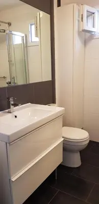 a bathroom with a white sink and a toilet at O Festival Palace, terrace with panoramic sea view in Cannes