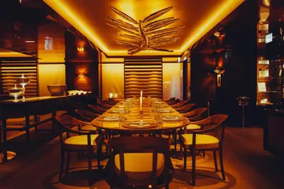a long dining room with a long table and chairs at Hôtel Martinez, in The Unbound Collection by Hyatt in Cannes