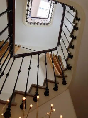 a mirror on the top of a staircase with lights at Hotel Alexandre III in Cannes