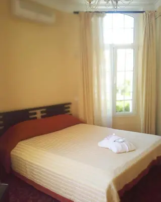 a bedroom with a bed with two towels on it at Hotel Alexandre III in Cannes