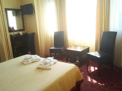 a hotel room with a bed with towels on it at Hotel Alexandre III in Cannes