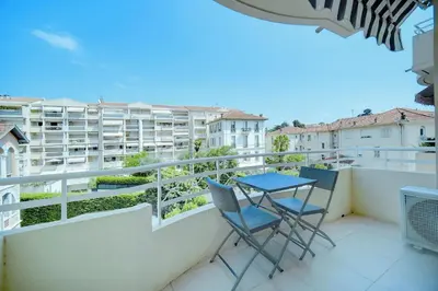 a balcony with two chairs and a table on it at IMMOGROOM - Terrace - 2 bedrooms - Downtown - Air conditioning - Wifi in Cannes