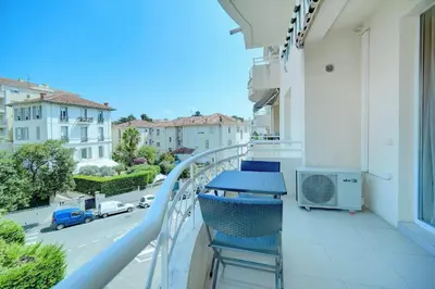 a balcony with chairs and a view of a street at IMMOGROOM - Terrace - 2 bedrooms - Downtown - Air conditioning - Wifi in Cannes