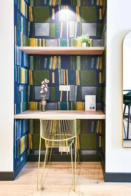 a desk in a room with a wall of books at Florella Croisette Apartment in Cannes
