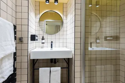 a bathroom with a sink and a mirror at Florella Croisette Apartment in Cannes