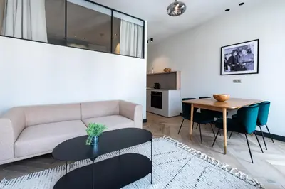 a living room with a couch and a table at Florella Croisette Apartment in Cannes