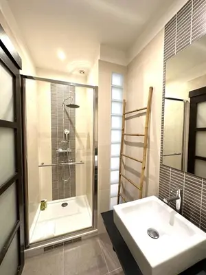 a bathroom with a shower and a white sink at 3 bedrooms with sea view - 4 min Palais & beaches in Cannes