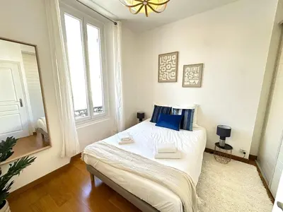 a bedroom with a bed and a large window at 3 bedrooms with sea view - 4 min Palais & beaches in Cannes