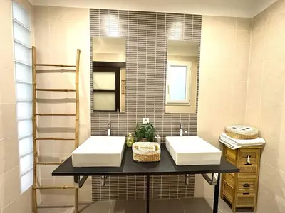 a bathroom with two sinks and a mirror at 3 bedrooms with sea view - 4 min Palais & beaches in Cannes