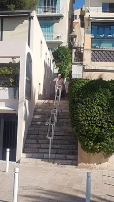 a man sitting on a ladder on some stairs at CLEM SOLEIL in Cannes