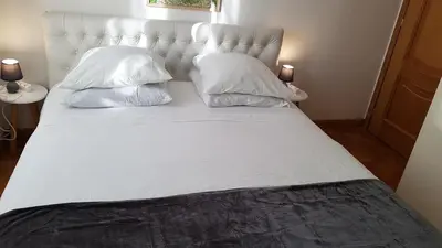 a large white bed with two pillows on it at CLEM SOLEIL in Cannes