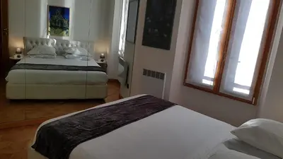a bedroom with two beds and two windows at CLEM SOLEIL in Cannes