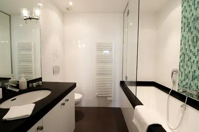 a white bathroom with a sink and a toilet at Residence Bivouac in Cannes
