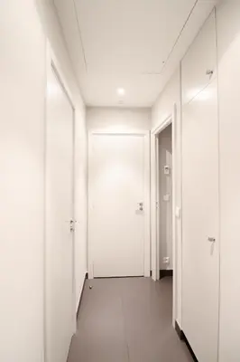an empty hallway with white walls and doors at Residence Bivouac in Cannes
