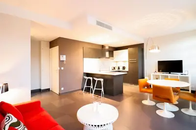 a living room with a couch and a table at Residence Bivouac in Cannes