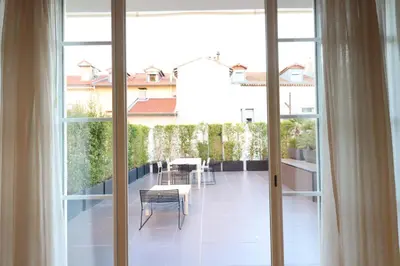 a balcony with a table and chairs and windows at Residence Bivouac in Cannes