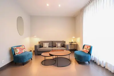 a living room with a couch and a table and chairs at Residence Bivouac in Cannes