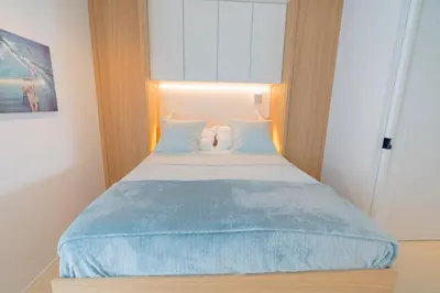 a bed in a room with a large window at Blvd De La Croisette 82A, Cannes, La Réale in Cannes
