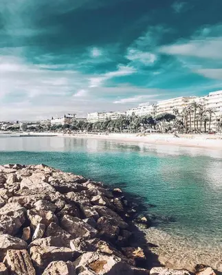 a view of a beach with buildings in the background at Blvd De La Croisette 82A, Cannes, La Réale in Cannes