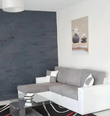 a living room with a couch and a table at Appartement charmant avec vue sur la mer au Cannet - 58 m² in Le Cannet