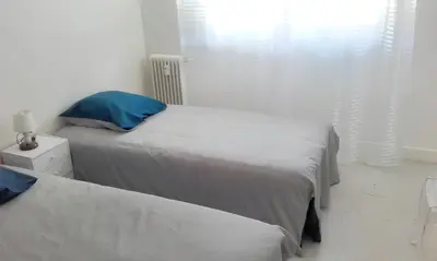 a bedroom with two beds and a window at Appartement charmant avec vue sur la mer au Cannet - 58 m² in Le Cannet