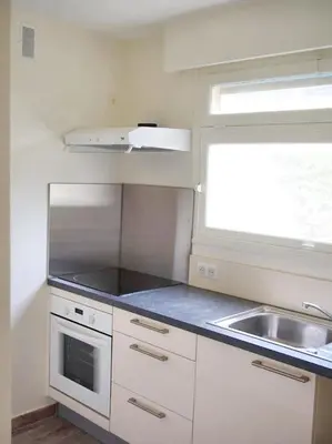 a small kitchen with a sink and a window at Appartement charmant avec vue sur la mer au Cannet - 58 m² in Le Cannet