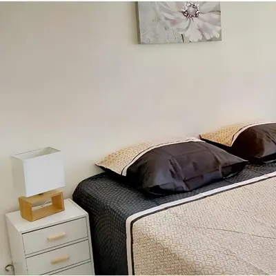 a bedroom with two twin beds and a night stand with a nightstand at Appartement charmant avec vue sur la mer au Cannet - 58 m² in Le Cannet