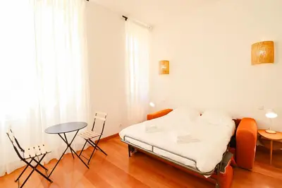 a bedroom with a bed and a table and chairs at Residence Buttura in Cannes
