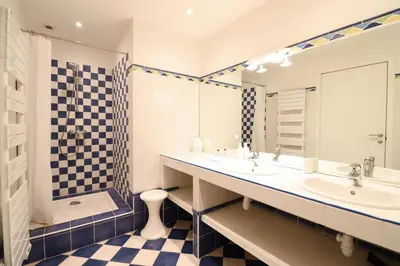 a bathroom with two sinks and a shower at Residence Buttura in Cannes