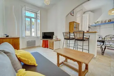 a living room with a couch and a table at IMMOGROOM - Cosy Apartment - Quiet Place - Provencal style in Cannes