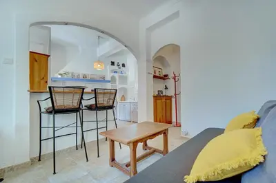 a living room with a couch and a table at IMMOGROOM - Cosy Apartment - Quiet Place - Provencal style in Cannes